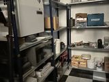 a refrigerator and shelves in a room with a checkered floor
