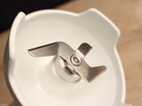 a white plate with a metal object on top of it