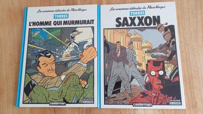 two comics are sitting on a table next to each other
