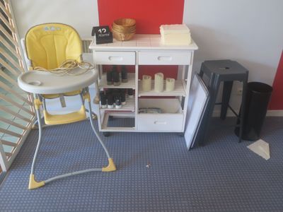 a baby highchair in the corner of a room