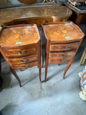 deux tables en bois avec des tiroirs et un miroir à l'arrière-plan