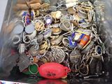 a container full of assorted key chains and other items