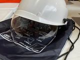 a white hard hat sitting on top of a blue bag
