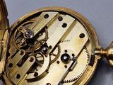 a close up of a pocket watch on a table