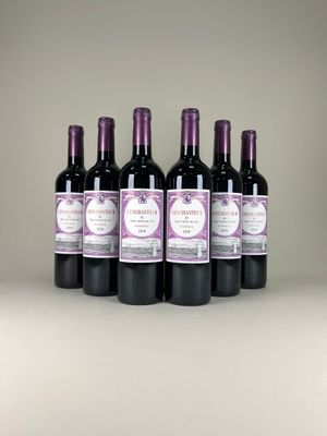 six bottles of wine are lined up on a table