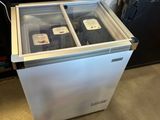 a refrigerator with two bottles of wine inside of it