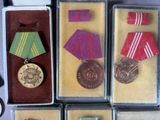five medals and a medal in a display case