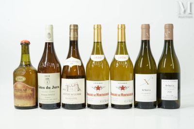 several bottles of wine are lined up on a white surface