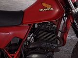 a red motorcycle that is parked in a garage