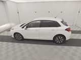 a picture of a small white car in a garage