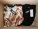 three shirts in a box with a price tag on them
