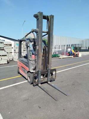 a forklift that is sitting in the middle of a parking lot