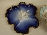 two decorative dishes that are sitting on a table