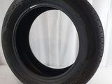 a close up of a tire on a white surface with a white curtain in the background