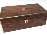 an old wooden box with a metal handle on a white surface
