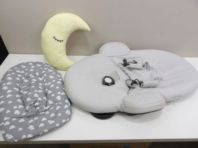 a white table topped with pillows and a stuffed animal