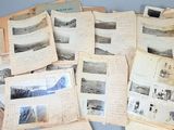 a pile of old photographs and papers on a table