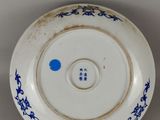 a blue and white plate with a blue flower design on it