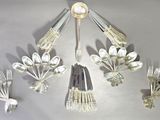 a lot of spoons and forks hanging from the ceiling