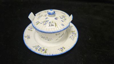 a small cup and saucer sitting on a black surface