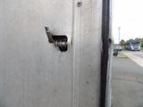 a close up of a metal door with a latch on it