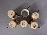 six coffee mugs sitting on top of a table next to each other