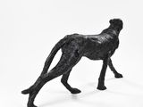 a black sculpture of a cheetah on a white background