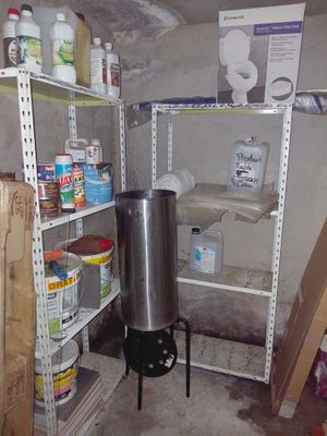 a stove in the corner of a room next to shelves
