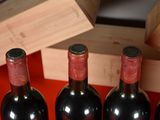 several bottles of wine are lined up in a row on a table