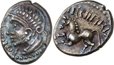 a close up of a coin with a face on it