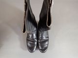 a pair of black boots that are sitting on a table