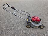 an image of a lawn mower sitting on the ground