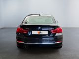 the back of a bmw 6 series sedan parked in a showroom