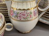 a lot of plates and cups that are on the table