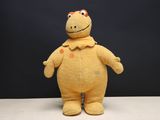 a yellow stuffed animal that is standing on a table