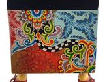a colorful box with a design on it and a pair of high heeled shoes