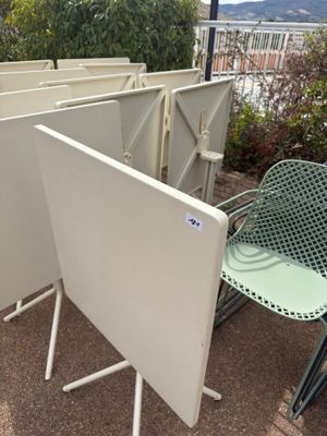 a lot of chairs and a table on the ground