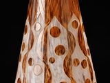 a brown and white vase that has a brown and white design on it