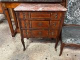 une petite table avec un plateau en marbre, à côté d'une chaise