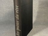 a black book sitting on top of a table next to a gray wall