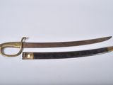 two swords with brass handles on a white surface
