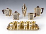 a silver plated tea set with four cups and a tray