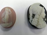 two cameos of women and a man are shown on a white surface