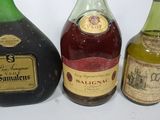 three bottles of liquor sit on a table next to each other
