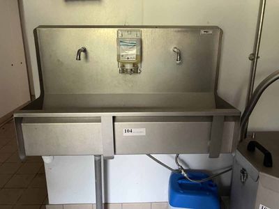 a stainless steel sink and a blue bucket on the floor