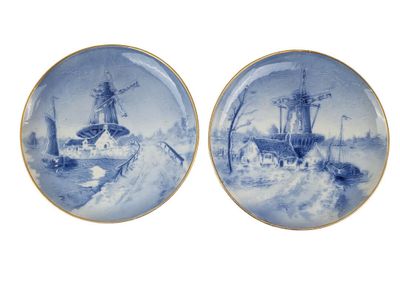 pair of blue and white plates with ships and windmills