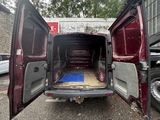 a red van with its doors open in a parking lot