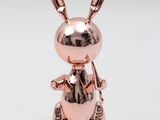 a close up of a metal rabbit statue on a white background