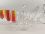 a lot of wine glasses and a vase on the table