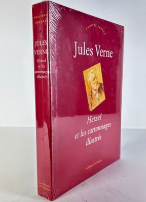 a red book sitting on top of a table next to a white wall